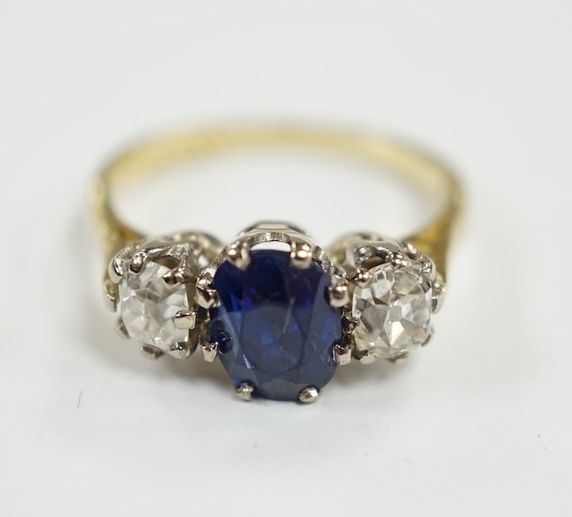 A late 1970's 18ct gold, sapphire and diamond set three stone ring, size J/K, gross weight 3.8 grams. Condition - fair